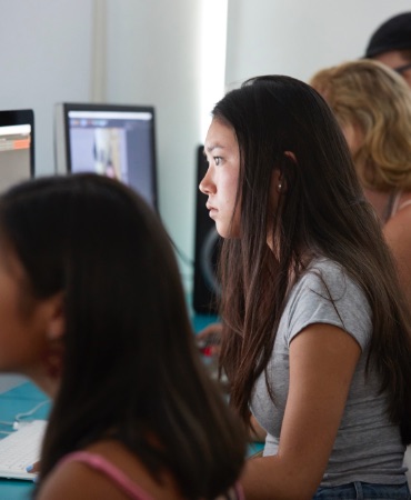 Students working on a computer in a classroom.