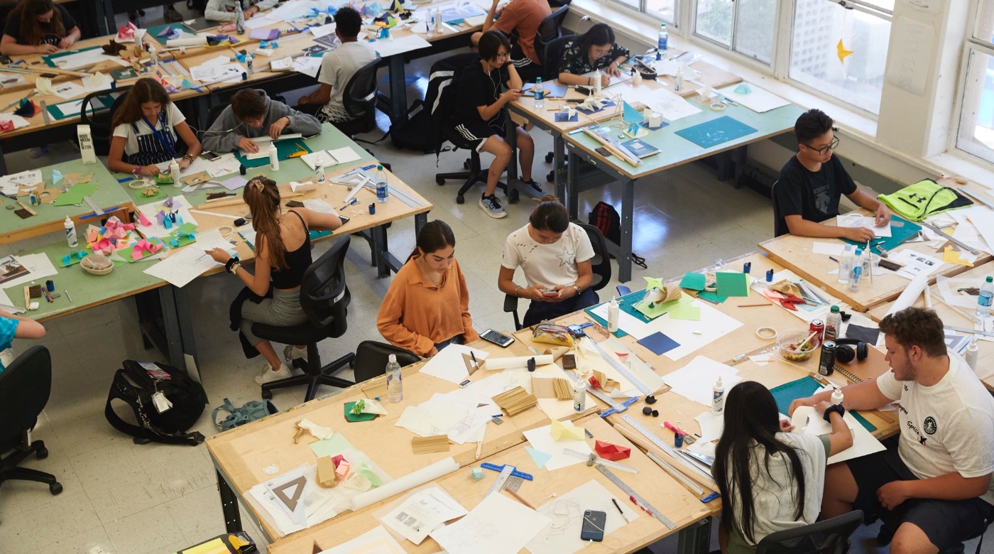 Overhead shot of students working together in a classroom on a project.