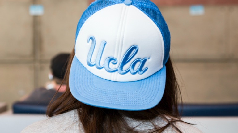 Student wearing a UCLA hat. The hat has UCLA written in blue letters.