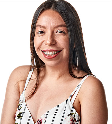 Portrait of Cynthia Hernandez. She is wearing a floral summer shirt, long dark brown hair and a bright smile with braces.