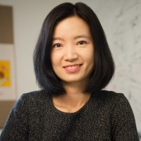 Portrait of Yizhou Sun. She is wearing a black shirt, shoulder length black hair and a smile.