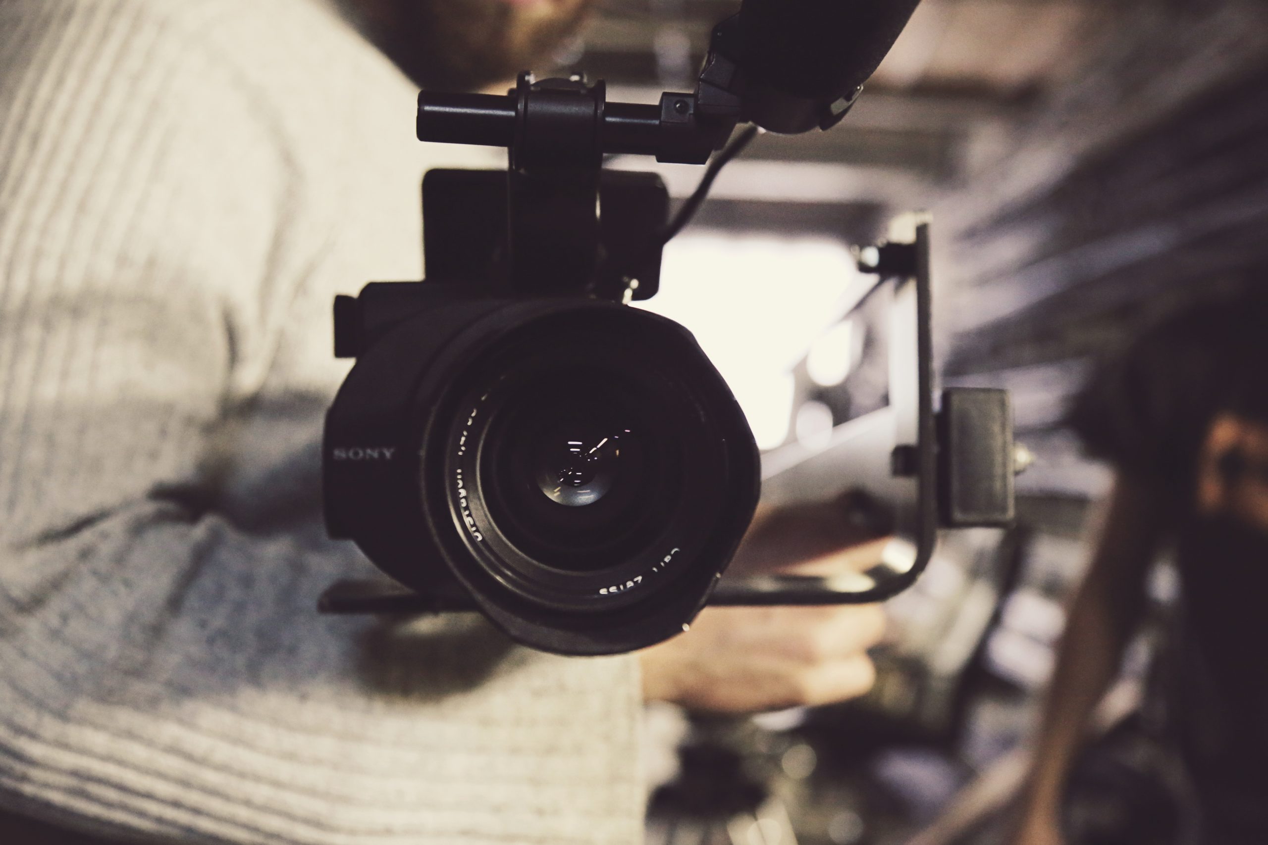 Closeup of professional video camera held in the right arm of a Film and Television Summer Institute UCLA student.